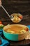 Soup with matzo dumplings and chicken with carrots and tomatoes is poured into bowl with ladle. Healthy Food for