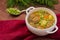 Soup with meatballs, carrots and peas. Wooden rustic background. Close-up