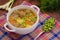 Soup with meatballs, carrots and peas. Wooden rustic background. Close-up