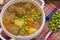 Soup with meatballs, carrots and peas. Wooden rustic background. Top view. Close-up