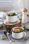 Soup with meatballs in metal mugs on wooden background