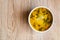 Soup of potatoes, spinach, carrots, meat. Bowl of soup on a wooden background. Copy space