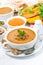 soup of pumpkin and lentils in a bowl on white background