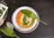 Soup with ravioli,carrots and ramson leafs in silver plate with vintage spoon