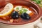 Soup saltwort with meat, potatoes, tomatoes, lemon, black olives