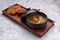 Soup with shrimps, sauce, bread, croutons, on a wooden board, on white background
