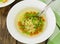 Soup with star shaped noodles, carrots and green peas