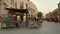 Souq Waqif Main street at sunset showing Traditional Antique shops, Coffee shops, people walking  and Qatari flag