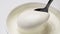 Sour cream with spoon  greek yogurt close up