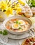 The sour soup Å Â»urek, polish Easter soup with the addition of sausage, hard boiled egg and vegetables in a ceramic bowl
