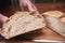 Sourdough bread loaf being cut after being baked in the oven