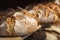 Sourdough bread on wooden shelves. Bakery shelf with golden crust bread