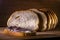 Sourdough slices freshly baked Sliced loaf of white bread on a chopping board light painting rustic style food