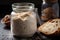 sourdough starter with ripe and bubbly crust in glass jar