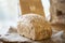Sourdough unleavened bread with oatmeal on rustic sackling. Loaf of natural freshly baked bread. Beige rustic food