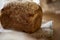 Sourdough unleavened bread on rustic sackling close up. Loaf of natural freshly baked bread with sesame. Beige food