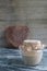 Sourdough on whole grain flour in glass jar and rye bread in shape heart on table, yeast-free organic bread, copy space