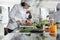 Sous chef chopping red pepper vegetable for gourmet dish served at dinner in restaurant.