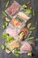 Sous Vide cooking concept. Vacuum packed ingredients arranged on wooden dyed background.