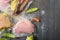 Sous Vide cooking concept. Vacuum packed ingredients arranged on wooden dyed background.