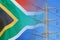 South Africa flag on electric pole background. Increasing energy consumption, energy crisis in South Africa. Price energy are