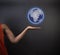 South African or African American teacher or businesswoman holding world earth globe