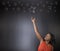 South African or African American woman teacher or student reaching for the stars success