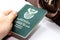 A South African passport next to a vintage travel bag. This image can be used to represent travel or immigration.
