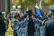 South African Police Services on Parade in the arena in formation , side view, flag unfurled and flying - wide angle
