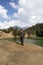 South Asian guy standing at a lake in Deoria tal Uttarakhand, India