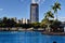 The South Bank Brisbane, beach in city centre with people and tall modern glass skyscrapers 1 William Street in background