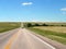 South Dakota open roads with rugged terrain, vehicles on roadway