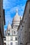 The south facade of the basilica of the Sacre-Coeur, or sacred heart,through the streets of Montmartre, Paris