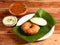 South indian breakfast combination of Medu vada and Idli or idly is a traditional and popular Food served with bowls of chutney