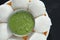 South Indian breakfast recipe Idly or Idli / rice cake served with coriander mint chutney, selective focus