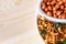 South indian spicy crunchy mix Nimco or Namkeen and spicy coated peanut white bowl wooden background
