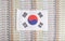 South Korea flag on a background from dollar banknotes. Concept of the relationship of the South korea money in relation