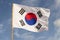 South Korea flag waving against cloudy blue sky