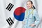 South Korea healthcare concept with doctor on flag background. Medical insurance, work or study in the country
