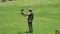 SOUTH KOREA - MAY 28, 2018: Falconer Training Harris Hawk on Field