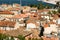 South Mediterranean small city houses with orange shingles roofs from above aerial shot