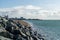 South parade pier in Southsea, Hampshire with waves hitting rocks in the foreground