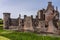 South side of Caerlaverock Castle under blue sky, Scotland UK.