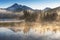 South Sister and Broken Top reflect over the calm waters of Sparks Lake at sunrise in the Cascades Range in Central Oregon, USA in