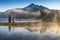 South Sister and Broken Top reflect over the calm waters of Sparks Lake at sunrise in the Cascades Range in Central Oregon, USA in