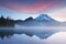 South Sister and Broken Top reflect over the calm waters of Sparks Lake at sunrise in the Cascades Range in Central Oregon, USA in