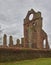 The South Transept of Arbroath Abbey Ruins with its distinctive round Beacon Window, lit up for Mariners at Night.