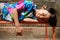 Southeast Asian ethnicity little boy lying down on a bench having sunbathing in the morning at home