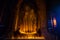 Southeast Asian neophyte praying with candle light in a Buddihist temple