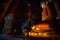 Southeast Asian neophyte praying with candle light in a Buddihist temple